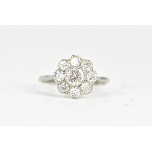 48 - A diamond 18ct white gold and platinum daisy ring, featuring a central bezel set brilliant round cut... 