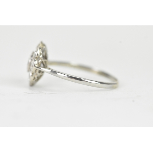 48 - A diamond 18ct white gold and platinum daisy ring, featuring a central bezel set brilliant round cut... 