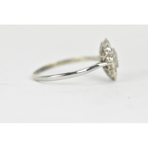 48 - A diamond 18ct white gold and platinum daisy ring, featuring a central bezel set brilliant round cut... 