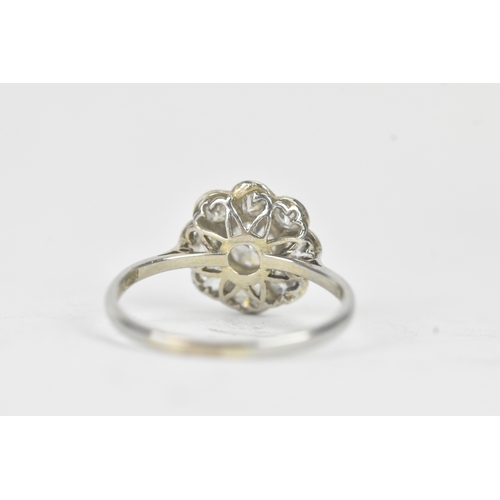 48 - A diamond 18ct white gold and platinum daisy ring, featuring a central bezel set brilliant round cut... 