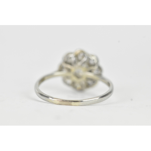 48 - A diamond 18ct white gold and platinum daisy ring, featuring a central bezel set brilliant round cut... 
