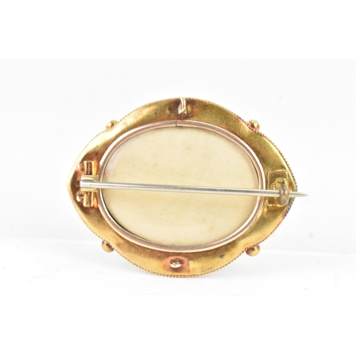 49 - A Victorian yellow metal mourning brooch, tested as 14ct gold, featuring a central starburst design,... 