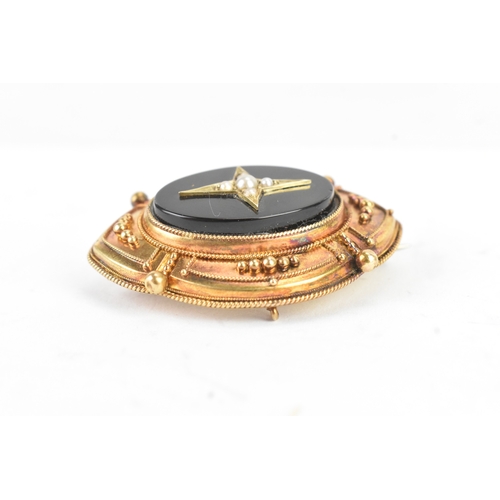 49 - A Victorian yellow metal mourning brooch, tested as 14ct gold, featuring a central starburst design,... 