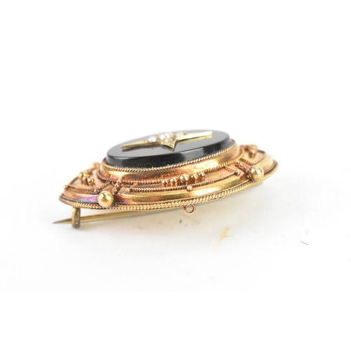 49 - A Victorian yellow metal mourning brooch, tested as 14ct gold, featuring a central starburst design,... 