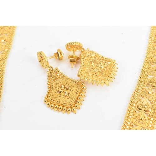 5 - A yellow gold filigree necklace and matching pair of drop earrings, testing as 20-22ct gold, the nec... 