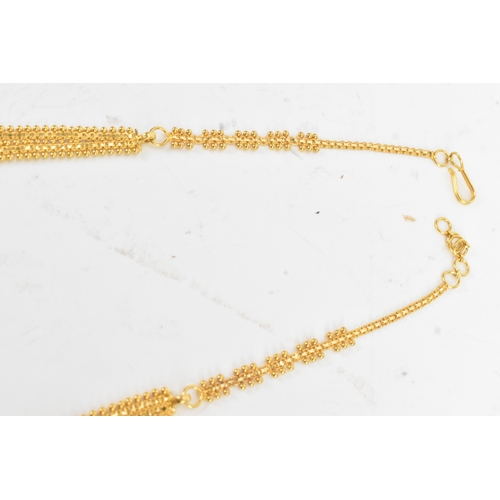 5 - A yellow gold filigree necklace and matching pair of drop earrings, testing as 20-22ct gold, the nec... 