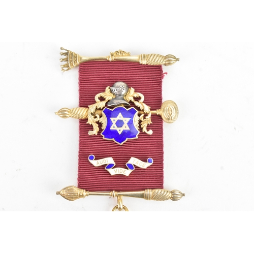 52 - A 9ct yellow gold Masonic Jewel the ribbon-mounted suspension with crossed sceptres, helmet and blue... 
