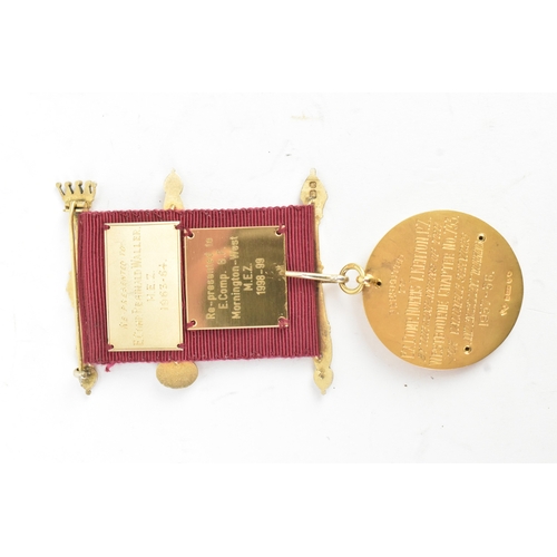 52 - A 9ct yellow gold Masonic Jewel the ribbon-mounted suspension with crossed sceptres, helmet and blue... 