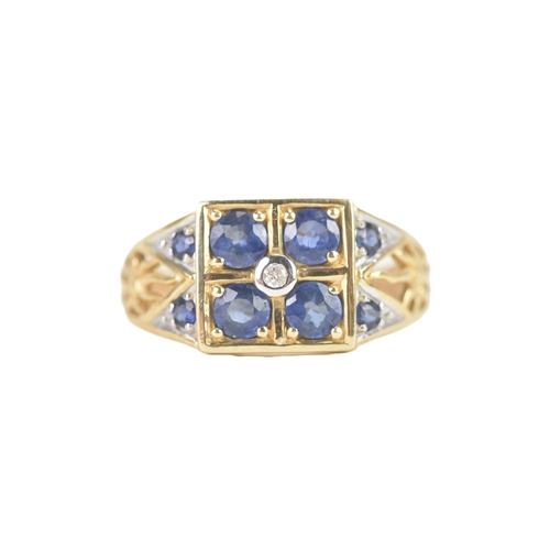 57 - A modern blue sapphire and diamond 14ct yellow and white gold cluster ring, featuring four round cut... 