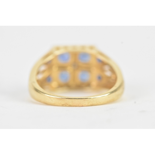 57 - A modern blue sapphire and diamond 14ct yellow and white gold cluster ring, featuring four round cut... 