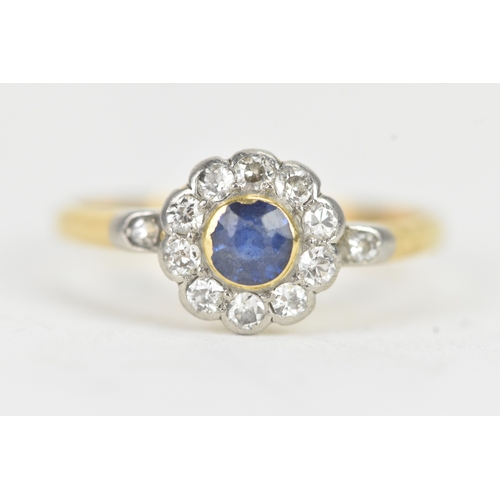 58 - A vintage diamond and blue sapphire 18ct yellow and white gold daisy ring, featuring a bezel set sap... 