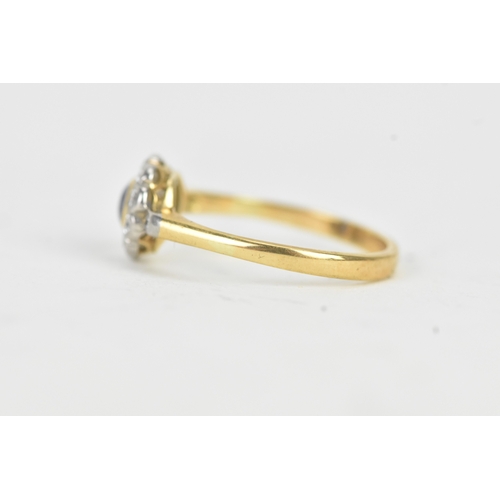 58 - A vintage diamond and blue sapphire 18ct yellow and white gold daisy ring, featuring a bezel set sap... 