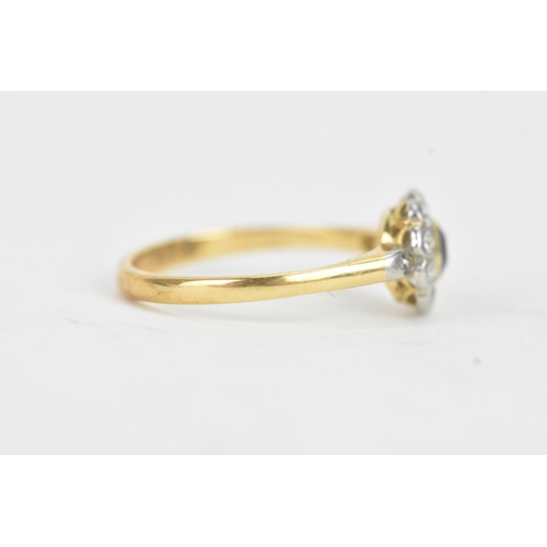 58 - A vintage diamond and blue sapphire 18ct yellow and white gold daisy ring, featuring a bezel set sap... 