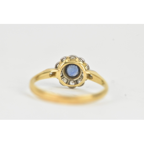 58 - A vintage diamond and blue sapphire 18ct yellow and white gold daisy ring, featuring a bezel set sap... 
