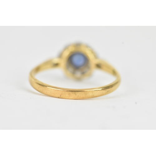 58 - A vintage diamond and blue sapphire 18ct yellow and white gold daisy ring, featuring a bezel set sap... 