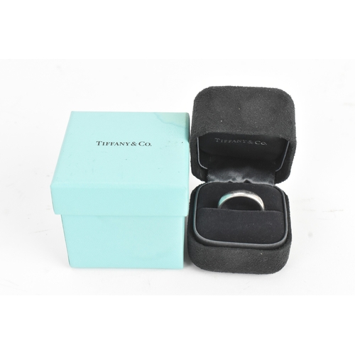 7 - A Tiffany platinum wedding band, with outer presentation box, size S 1/2, 9.4 grams
If there is no c... 