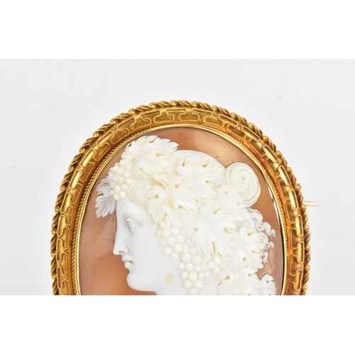 8 - A Victorian yellow gold shell cameo brooch, unmarked, carved in relief depicting a classical female ... 