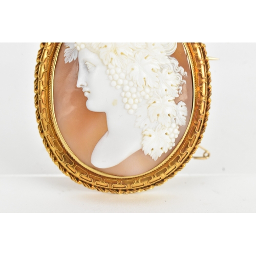 8 - A Victorian yellow gold shell cameo brooch, unmarked, carved in relief depicting a classical female ... 