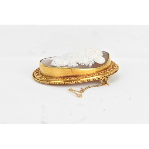 8 - A Victorian yellow gold shell cameo brooch, unmarked, carved in relief depicting a classical female ... 
