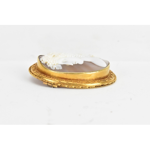 8 - A Victorian yellow gold shell cameo brooch, unmarked, carved in relief depicting a classical female ... 