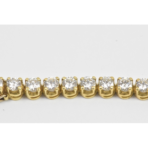 6A - A yellow gold diamond tennis bracelet with thirty-nine round brilliant cut claw set diamonds, each a... 