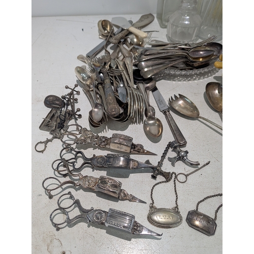 54 - Mixed silver plate and glassware to include a collection of toast racks, cutlery and others, along w... 