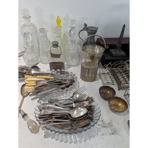 54 - Mixed silver plate and glassware to include a collection of toast racks, cutlery and others, along w... 