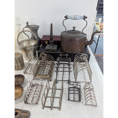 54 - Mixed silver plate and glassware to include a collection of toast racks, cutlery and others, along w... 