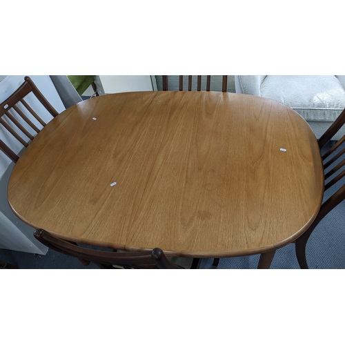 1 - A mid 20th century G-Plan teak extending table 72.5H x 142W together with six dining chairs
Location... 
