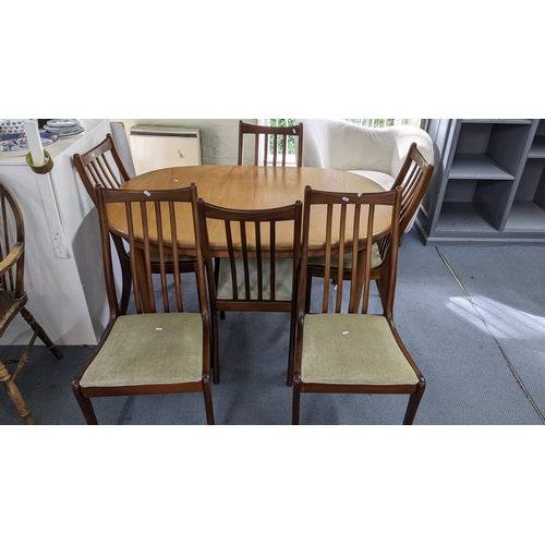 1 - A mid 20th century G-Plan teak extending table 72.5H x 142W together with six dining chairs
Location... 