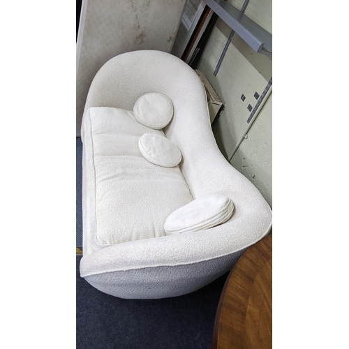 10 - A contemporary cream upholstered two-seater sofa on silt tapering metal legs, 83H x 165W
Location: B... 