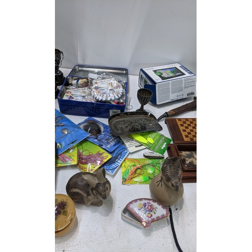 25 - A mixed lot to include silver plated trophies, Poole pottery ornaments, horn handled crumb scoop, lo... 