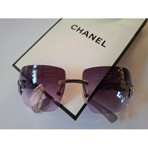 Chanel- A pair of early 2000's rimless sunglasses, style no:4287T having square purple gradient lenses and temples with graphite coloured hardware, serial no:L3569474 together with branded case ( as found) and bag. Location:
Condition: Case as found, scratches to both lenses-see additional photographs