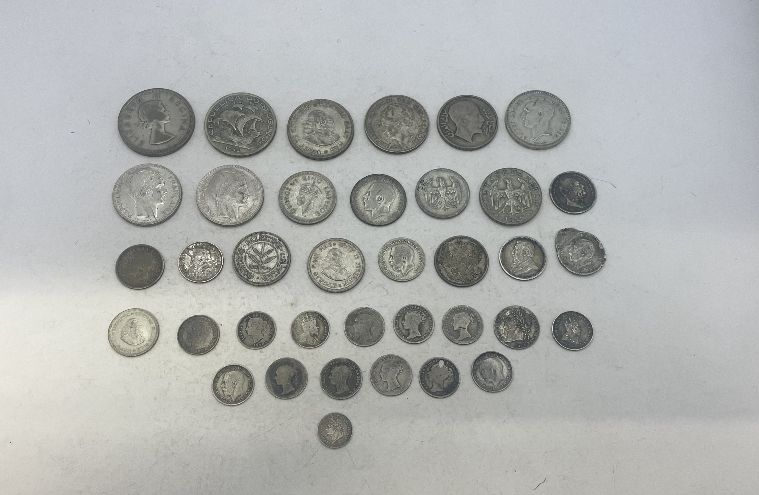 A group of mixed silver coins to include examples from UK (pre-1920 and ...