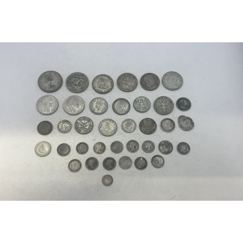 A group of mixed silver coins to include examples from UK (pre-1920 and ...