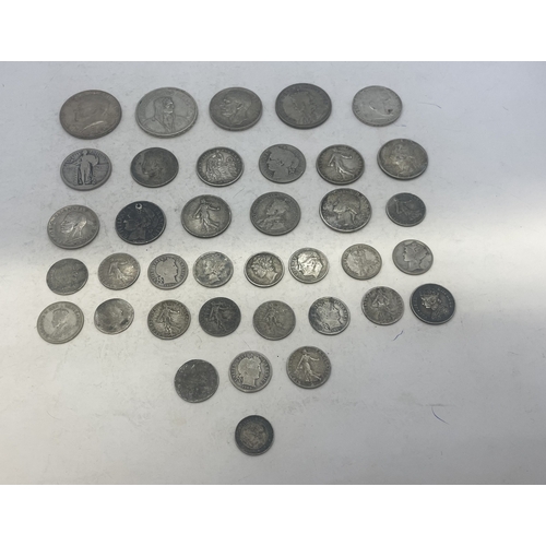 A group of mixed silver coins to include examples from USA, France ...