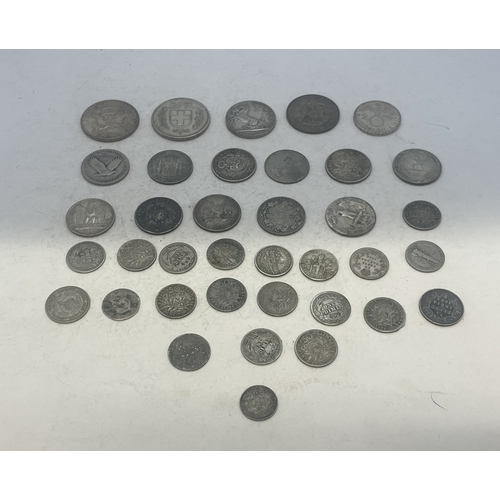 A group of mixed silver coins to include examples from USA, France ...