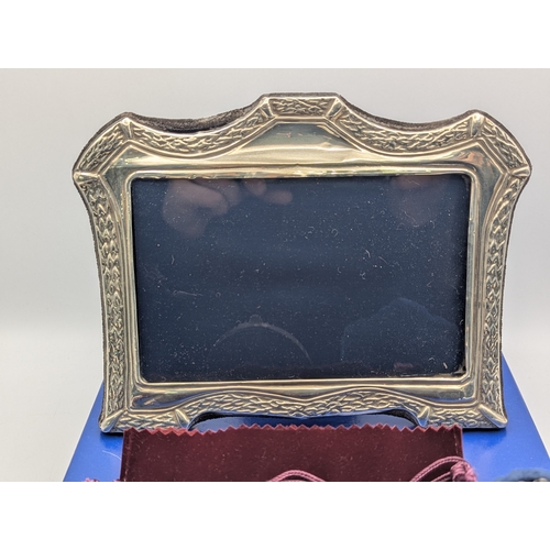 Four silver fronted easel back photograph frames, to include an ...