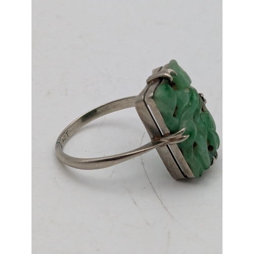 A jade and 9ct white gold dress ring, featuring a claw set, pierced ...