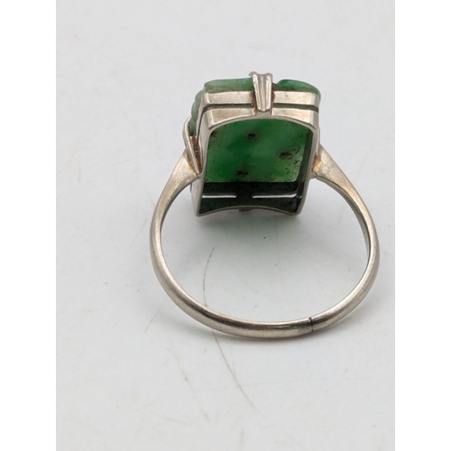 A jade and 9ct white gold dress ring, featuring a claw set, pierced ...