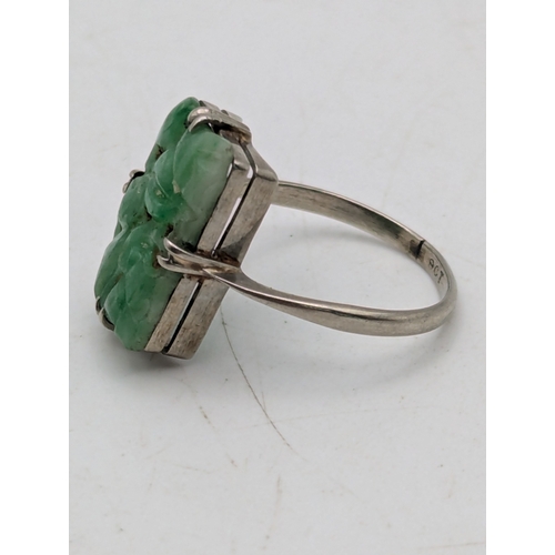 A jade and 9ct white gold dress ring, featuring a claw set, pierced ...