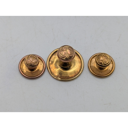 Three 9ct gold shirt button studs, having floral scroll decoration, 2 ...