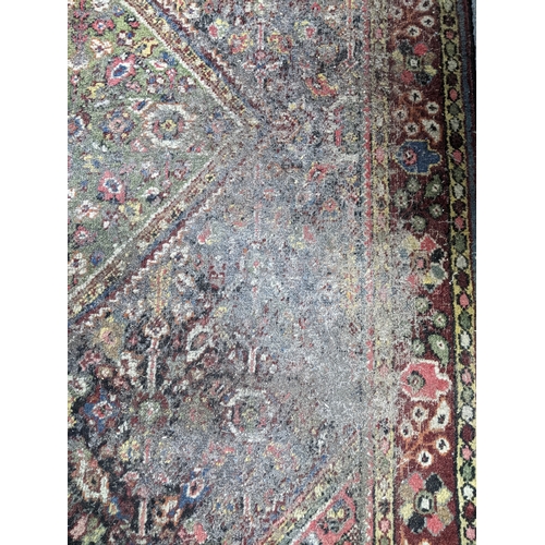 A group of three rugs to include a hand knotted Iranian rug with ...