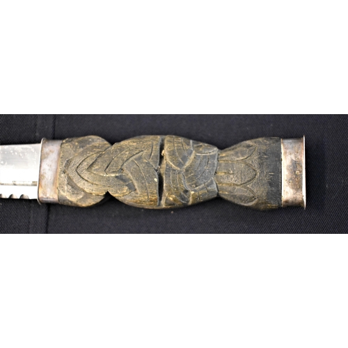 47 - Scottish Highland Dirk, a Celtic design on the handle with white-metal hilt and pommel and attachmen... 