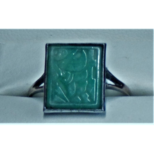 616 - A Jade and Gold ring, unusual designed stone with floral design etched into it. A lovely ring, c.192... 