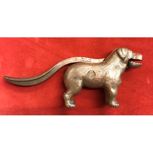 364 - 1920s dog shaped nutcracker, cast iron metal with a brass finish, made in England. Lift the tail to ... 