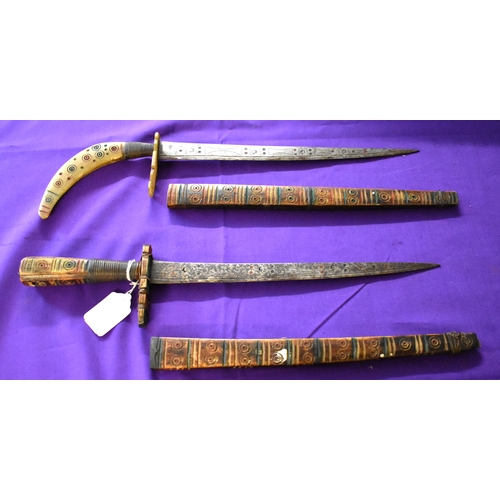 71 - African Tribal daggers, two ornate tribal with etching down the blades with red and green patterns. ... 