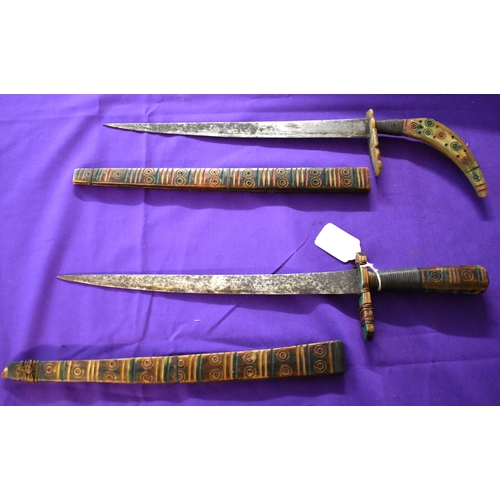 71 - African Tribal daggers, two ornate tribal with etching down the blades with red and green patterns. ... 