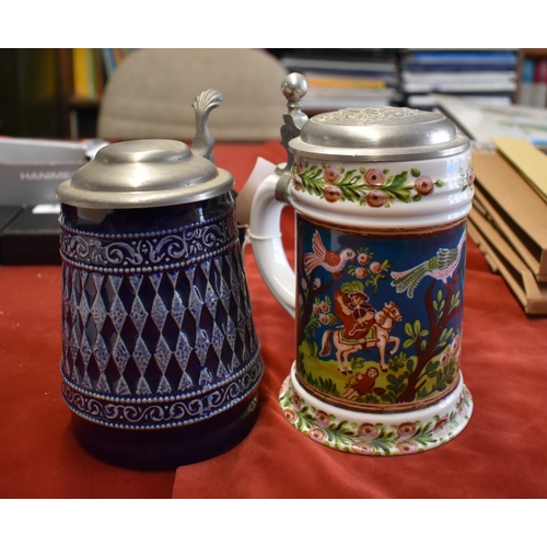 317 - Steins (3) - Ceramic steins, dark blue with white pattern, floral design on white back ground, pictu... 