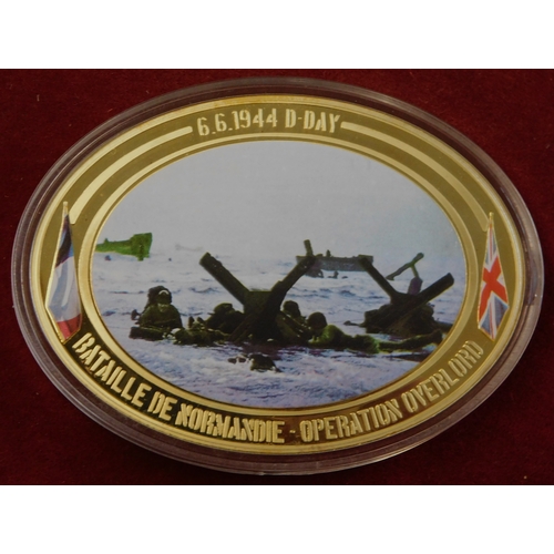 597 - Commemorative coins - (4) coins Operation Overload 1944, coloured war scenes on front, in case, imma... 